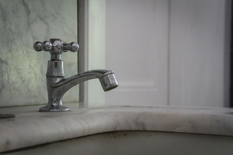 a tap over a bathroom sink